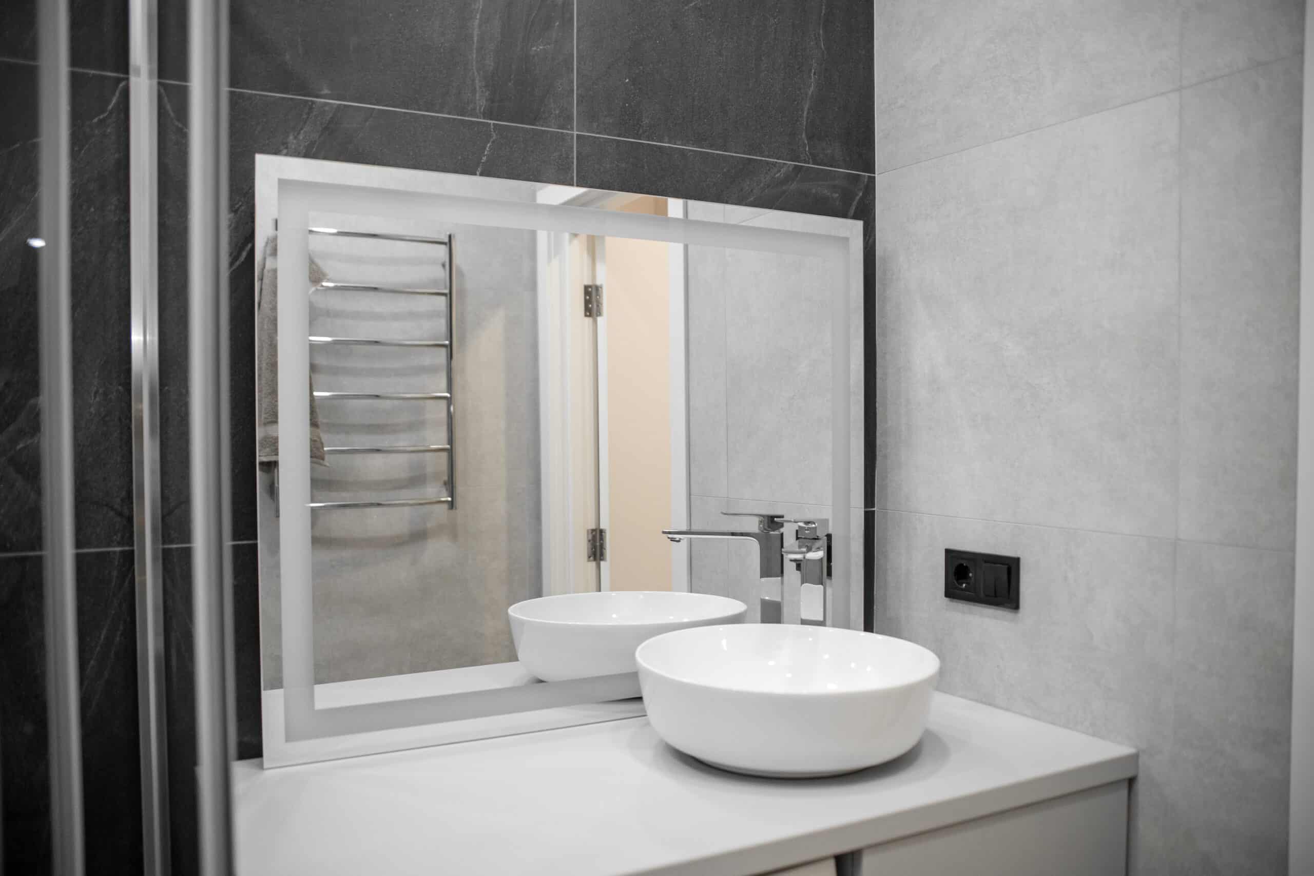 Bathroom interior with mirror and wash basin.
